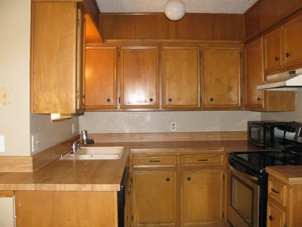 a kitchen with a sink and cabinets