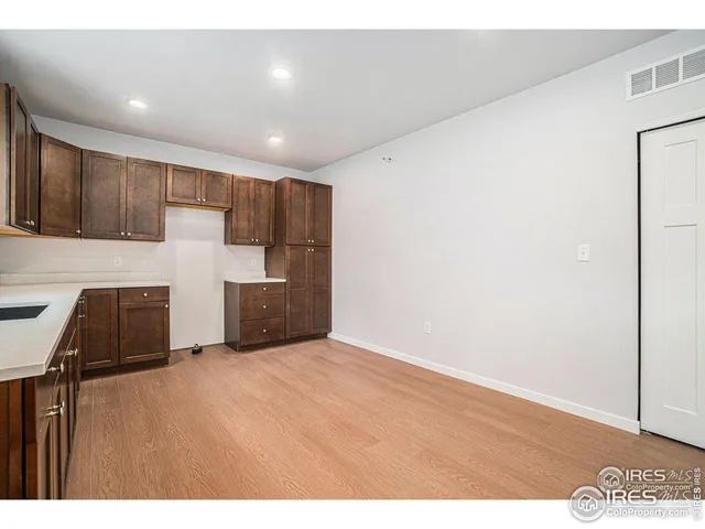 a view of kitchen with refrigerator and microwave