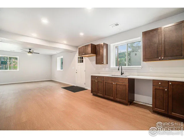 a kitchen with a sink cabinets and window