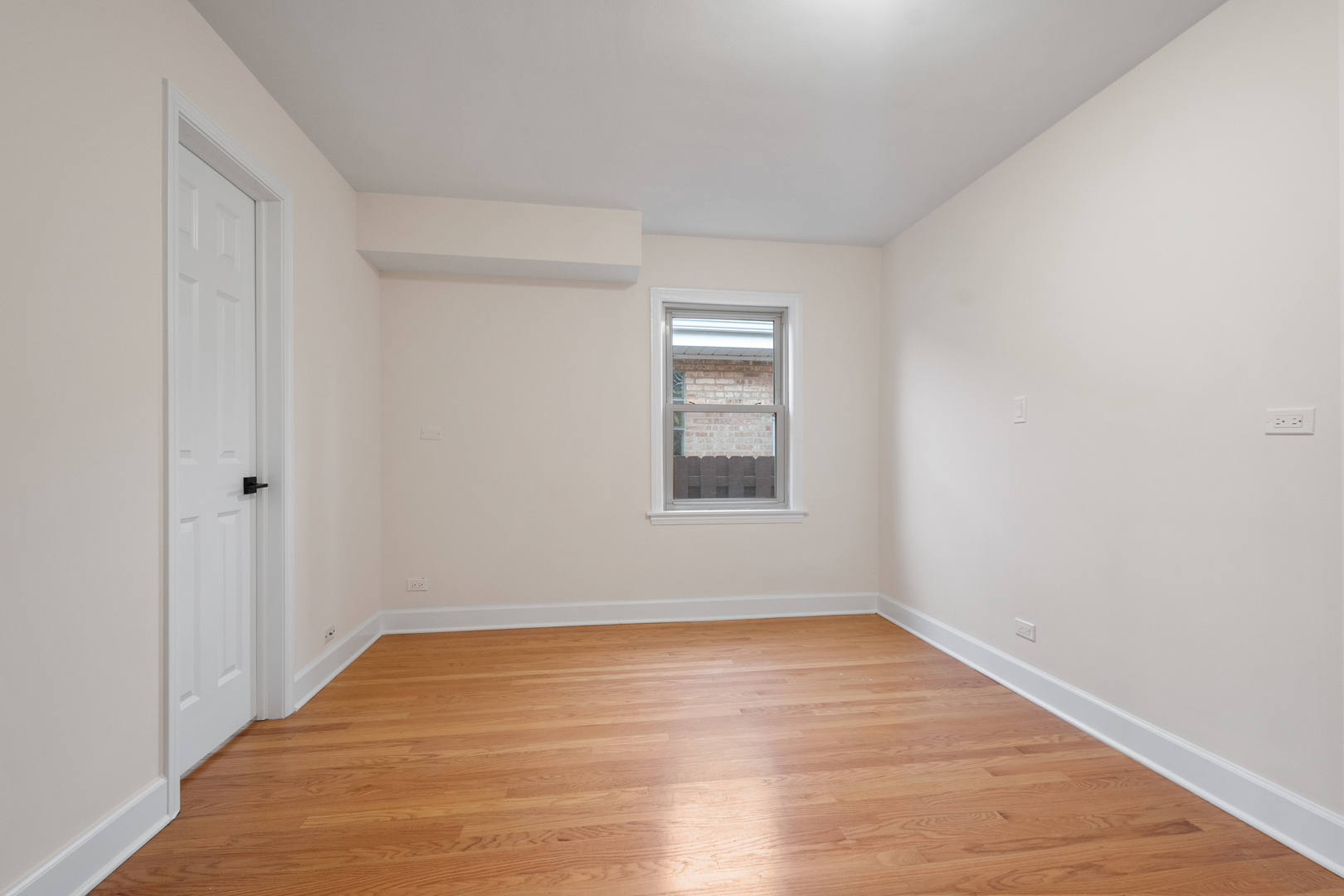 4701 Thatcher Avenue Norridge, IL 60706 - Photo 11 of 23 a view of an empty room with wooden floor and a window