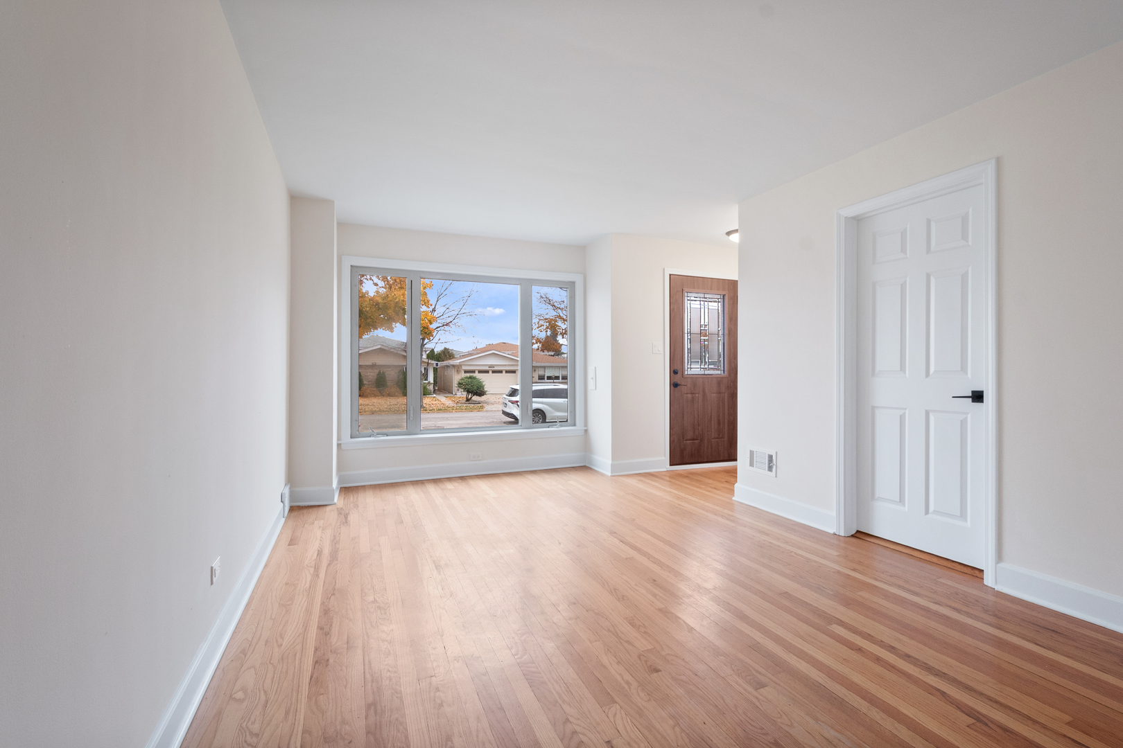 4701 Thatcher Avenue Norridge, IL 60706 - Photo 4 of 23 a view of an empty room with wooden floor and a window