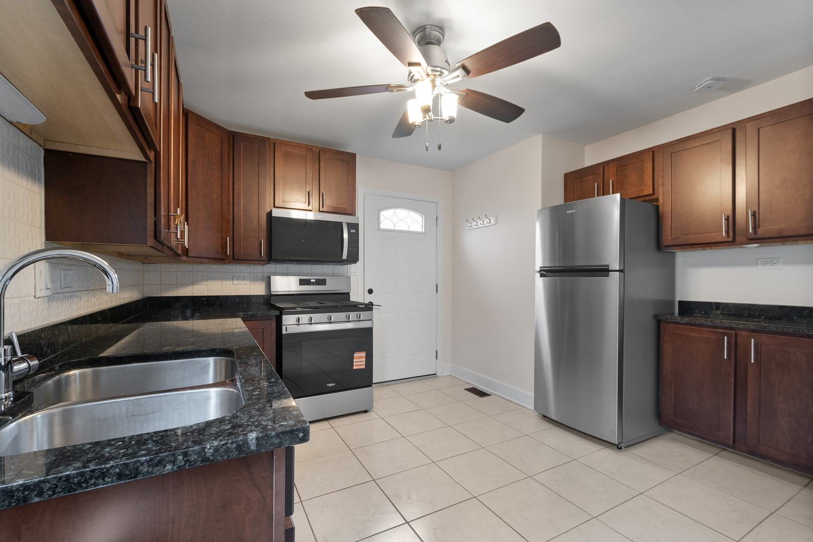 4701 Thatcher Avenue Norridge, IL 60706 - Photo 7 of 23 a kitchen with granite countertop a refrigerator and a sink