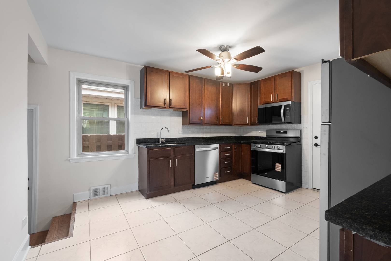 4701 Thatcher Avenue Norridge, IL 60706 - Photo 8 of 23 a kitchen with stainless steel appliances granite countertop a stove a sink and a refrigerator