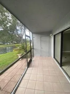 a view of an empty room with floor to ceiling windows