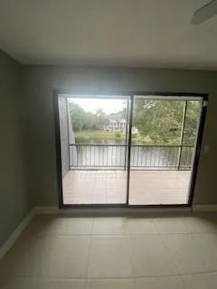 a view of empty room with large windows