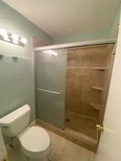 a bathroom with a toilet and shower