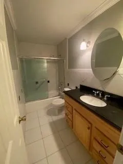 a bathroom with a granite countertop sink a mirror and shower