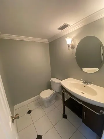 a bathroom with a sink mirror vanity and toilet