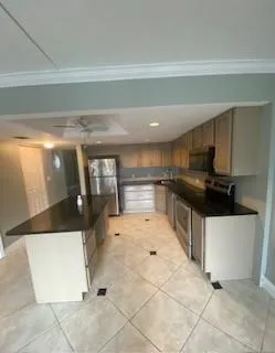 a kitchen with granite countertop a sink and a stove top oven