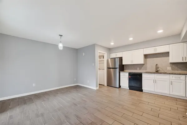 a view of a kitchen with a sink and a stove top oven