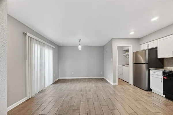 a view of a kitchen with a sink and a refrigerator
