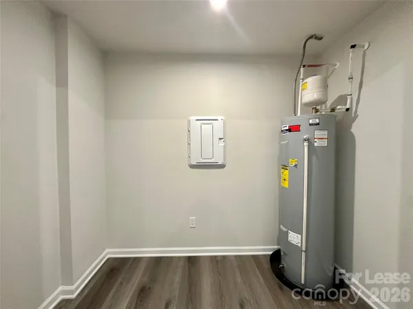 a view of storage and utility room with wooden floor
