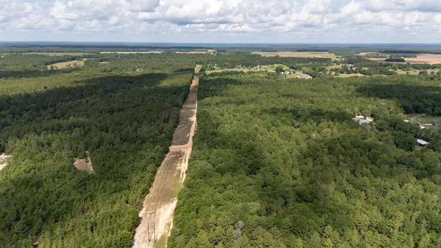 a view of a field with an ocean view