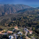 a view of a house with a mountain and a forest