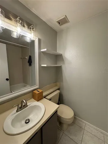 a bathroom with a sink toilet and mirror