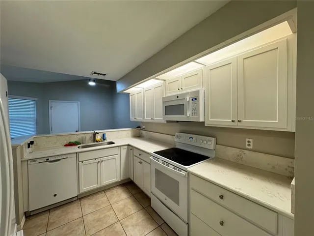 a kitchen with a sink and cabinets