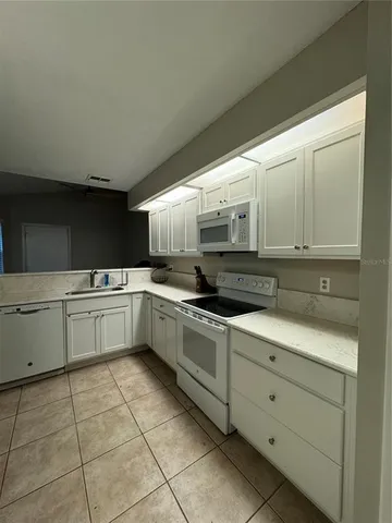 a kitchen with stainless steel appliances granite countertop a sink and cabinets