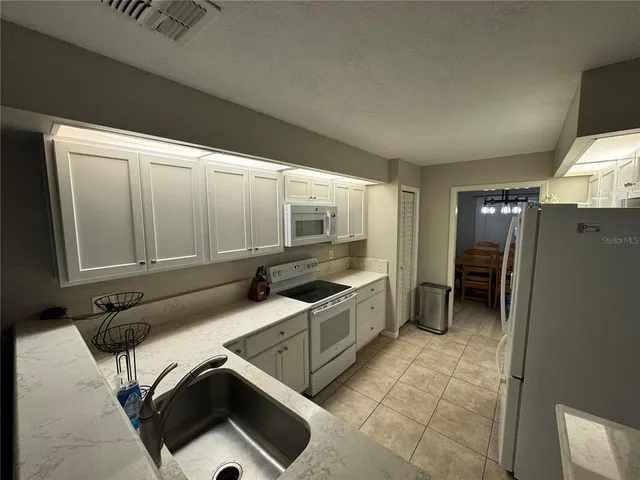a kitchen with a sink and cabinets