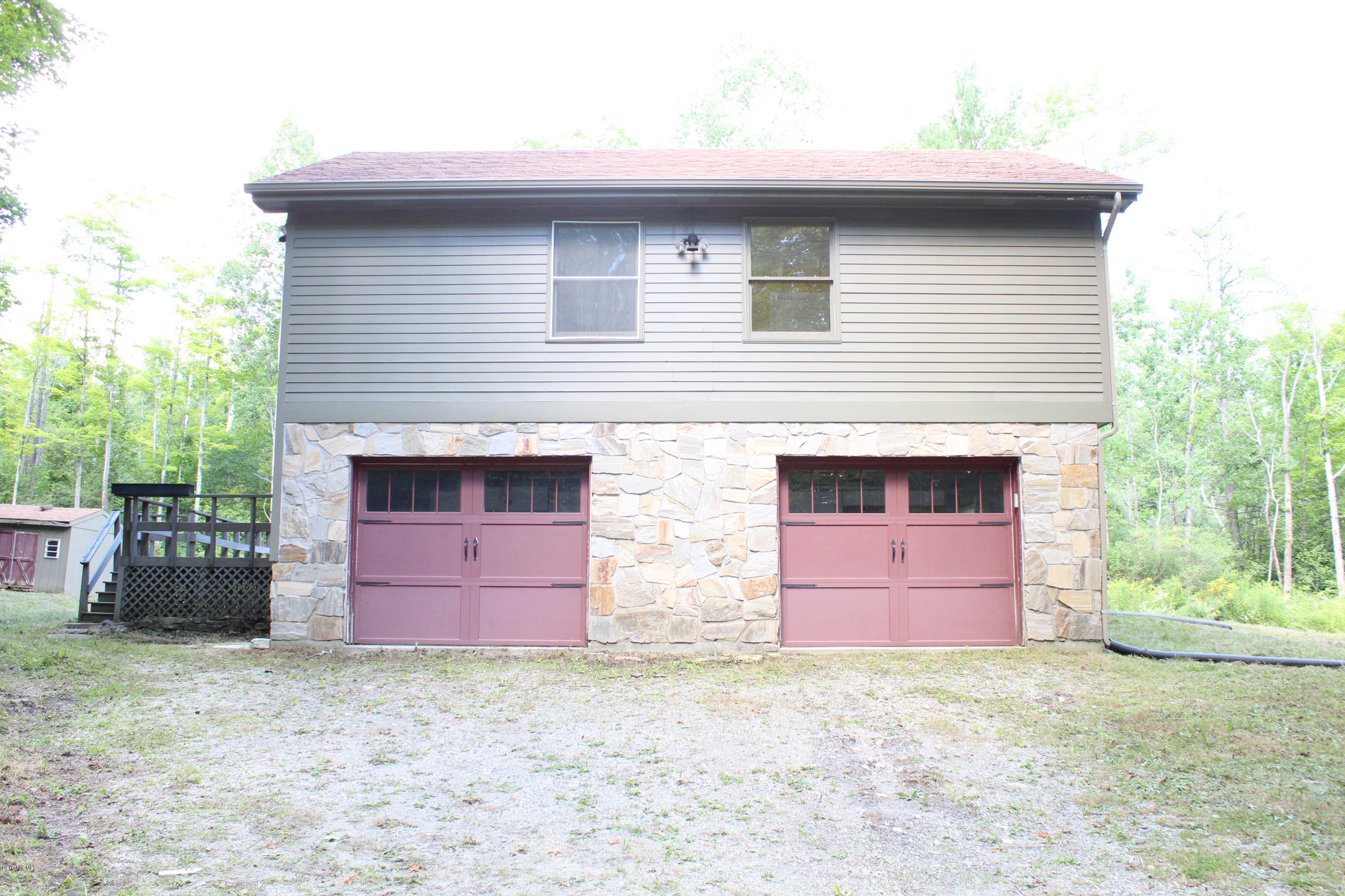 1090 State Road Richmond, MA 01254 - Photo 22 of 24 a front view of a house with a yard and garage
