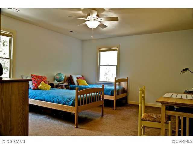 10800 Shingle Oak Road Chester, VA 23831 - Photo 11 of 11 a bedroom with furniture and a chandelier