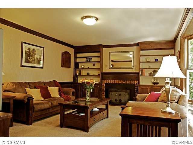 10800 Shingle Oak Road Chester, VA 23831 - Photo 3 of 11 a living room with furniture a fireplace and a flat screen tv