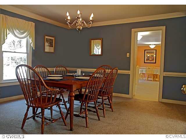 10800 Shingle Oak Road Chester, VA 23831 - Photo 6 of 11 a view of a dining room with furniture and chandelier