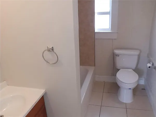 a view of a house with wooden fence