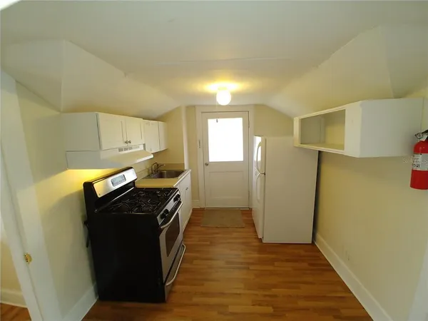 a kitchen with a stove and a refrigerator