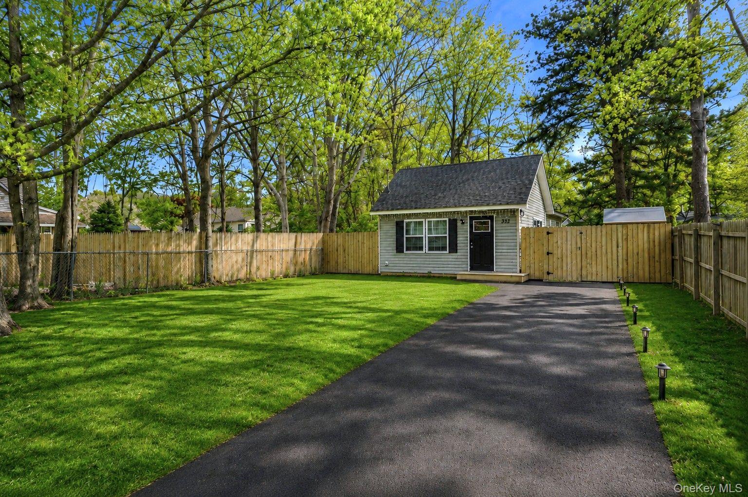 332 Commack Road Shirley, NY 11967 - Photo 4 of 25 a front view of a house with a garden