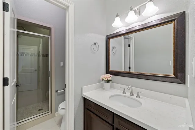 a bathroom with a sink a toilet and mirror