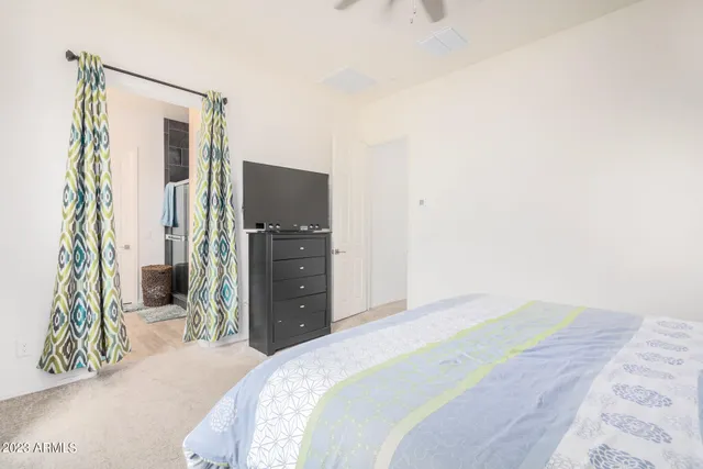 a bedroom with a bed and a mirror