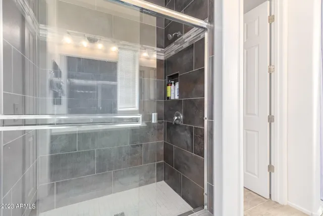 a bathroom with a glass shower door