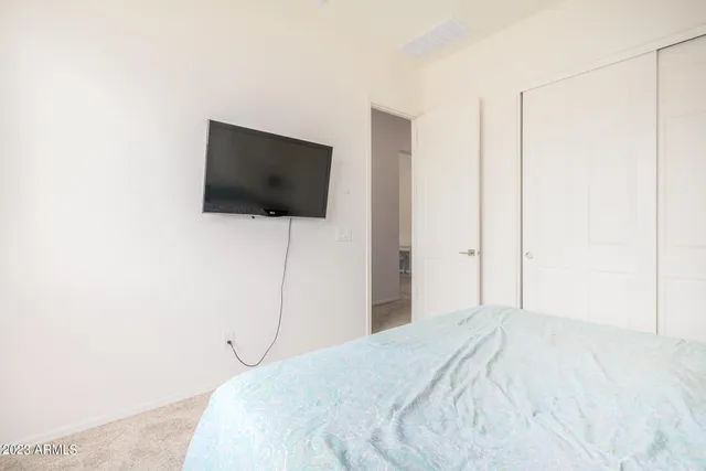 a bedroom with a bed and a flat screen tv