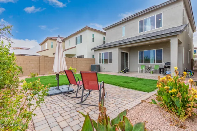 a view of a house with backyard sitting area and garden