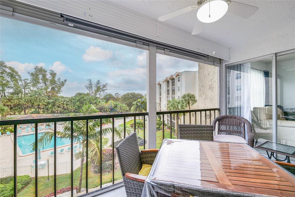 3930 Inverrary Boulevard, Unit 407D Lauderhill, FL 33319 - Photo 2 of 60 a view of a balcony with chair and wooden floor