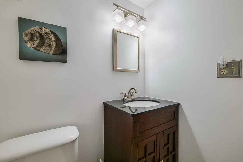 3930 Inverrary Boulevard, Unit 407D Lauderhill, FL 33319 - Photo 21 of 60 a bathroom with a toilet a sink and mirror