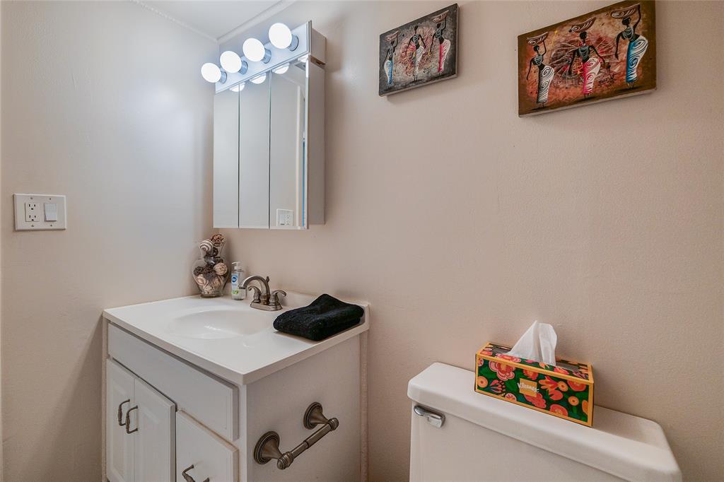 3930 Inverrary Boulevard, Unit 407D Lauderhill, FL 33319 - Photo 27 of 60 a bathroom with a sink and a stove with white cabinet