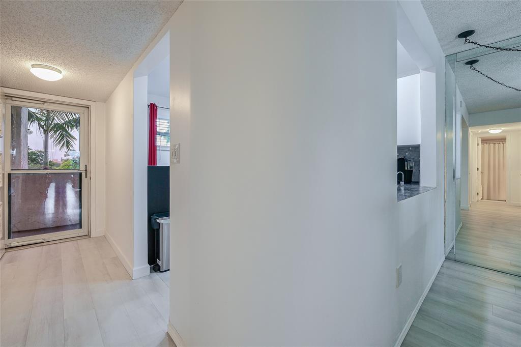 3930 Inverrary Boulevard, Unit 407D Lauderhill, FL 33319 - Photo 30 of 60 a view of a hallway with wooden floor and closet