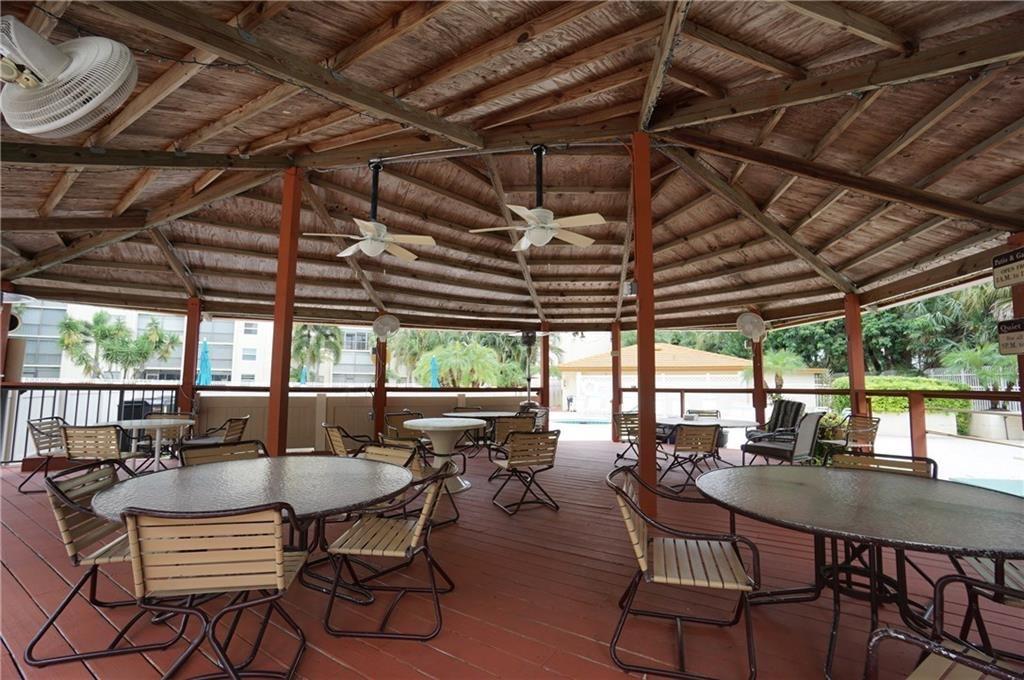 3930 Inverrary Boulevard, Unit 407D Lauderhill, FL 33319 - Photo 35 of 60 a view of a patio with a table and chairs