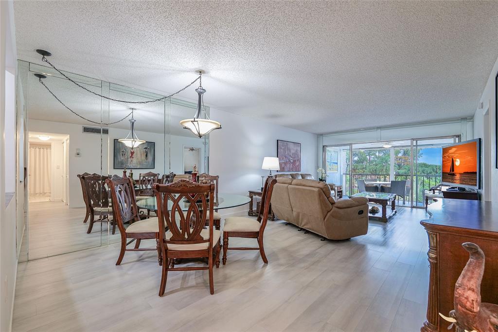 3930 Inverrary Boulevard, Unit 407D Lauderhill, FL 33319 - Photo 5 of 60 a view of a dining room with furniture window and wooden floor