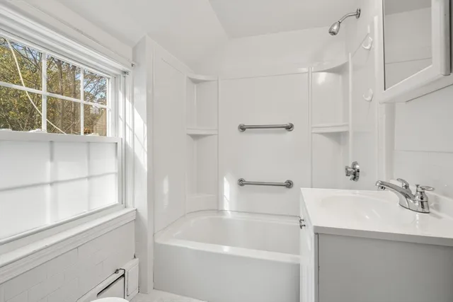 a white bath tub sitting next to a white sink
