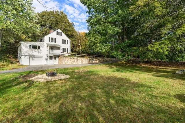 a view of a house with pool and a yard