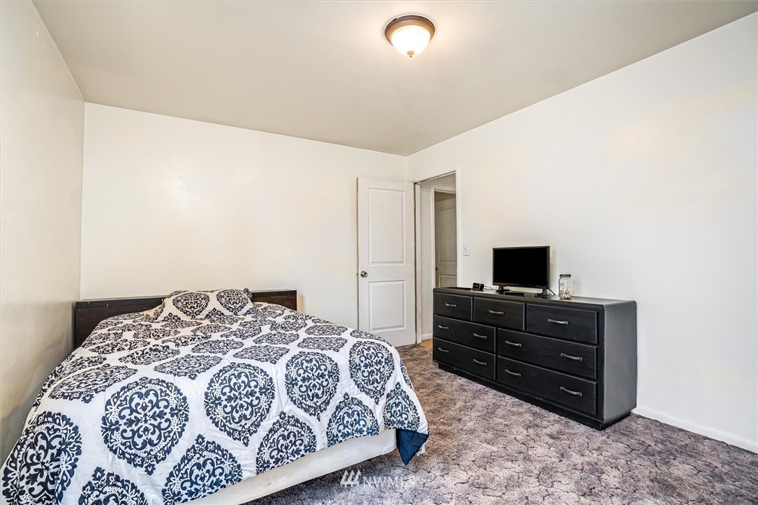 10701 School Land Road Southwest Rochester, WA 98579 - Photo 24 of 35 a bedroom with a bed and a television