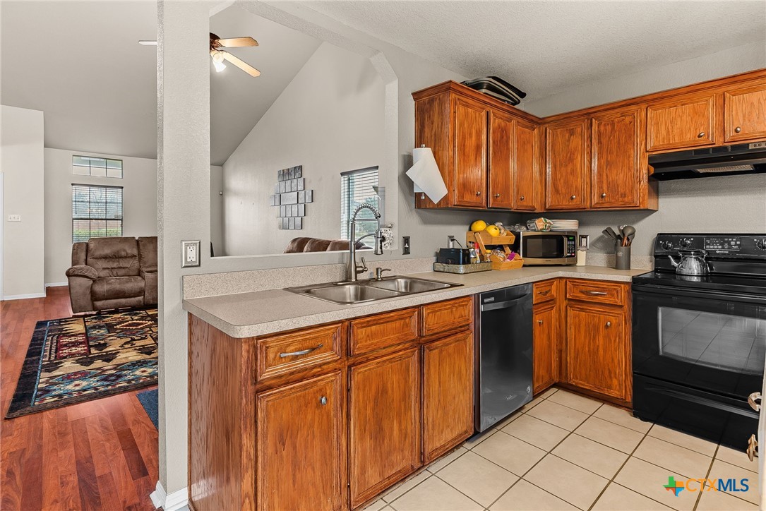 2500 Waterfall Drive Killeen, TX 76549 - Photo 8 of 29 a kitchen with stainless steel appliances granite countertop a sink stove and cabinets