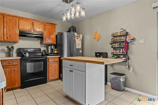 a kitchen with a sink cabinets and stainless steel appliances