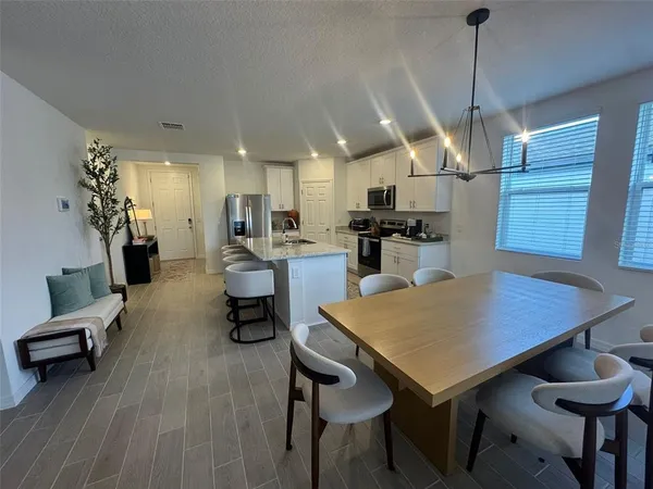 a kitchen with a table and chairs in it
