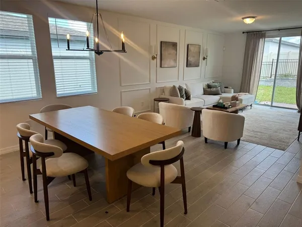 a view of a dining room with furniture and a window