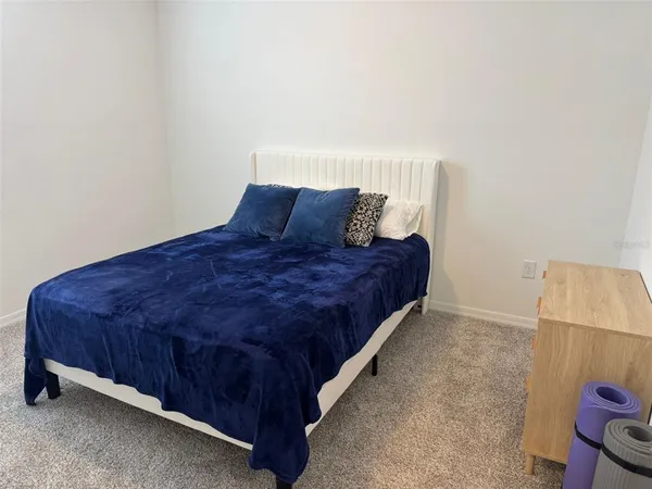 a large bed sitting in a bedroom next to a cabinet
