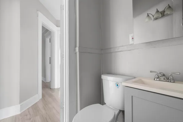 a bathroom with a sink mirror and toilet