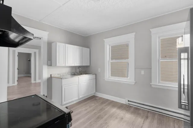 a room with a sink cabinets and utility room